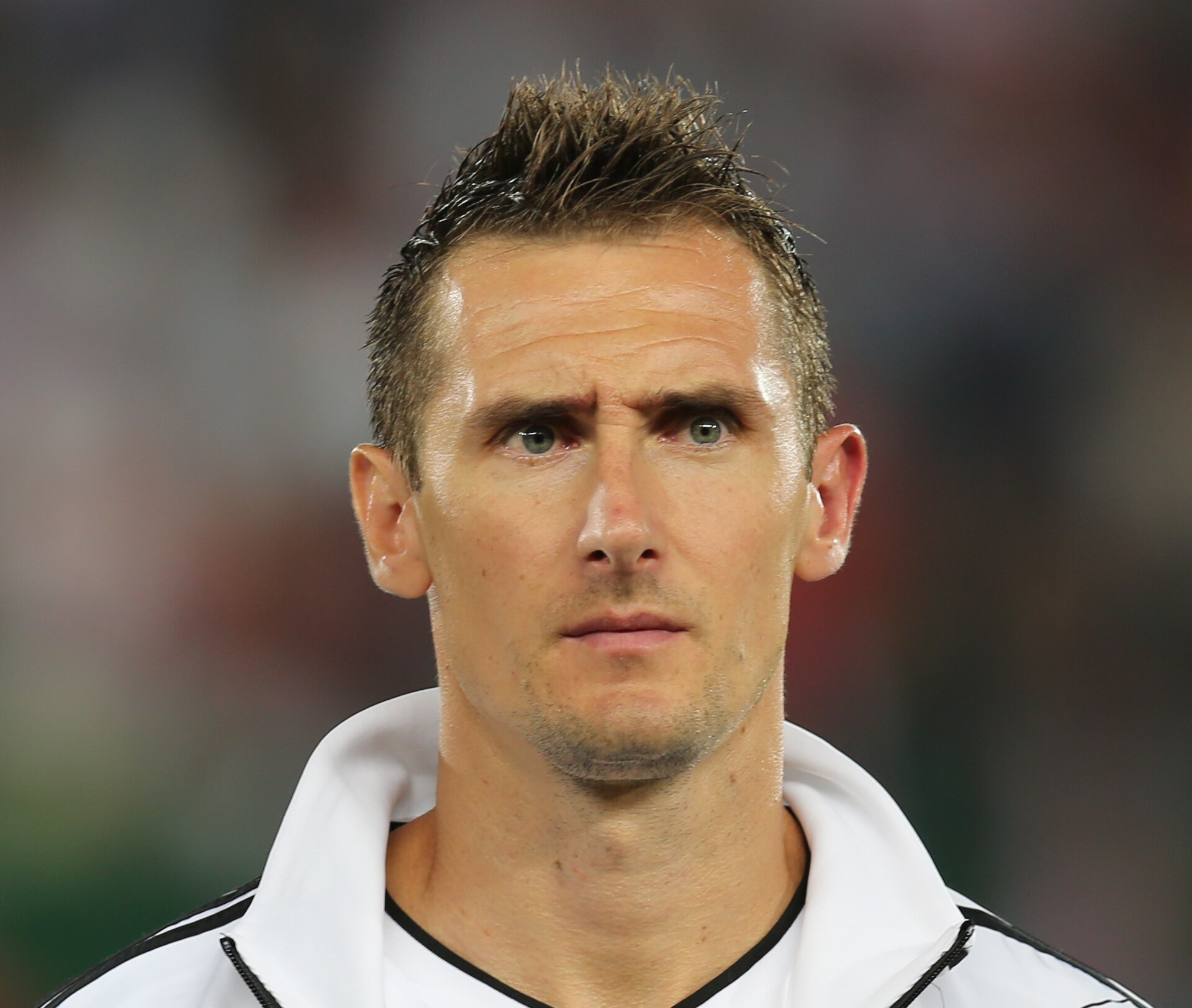 Miroslav Klose in the white Germany shirt with the number 11 during a 2012 World Cup qualifier